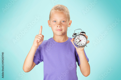 School boy showing alarm clock