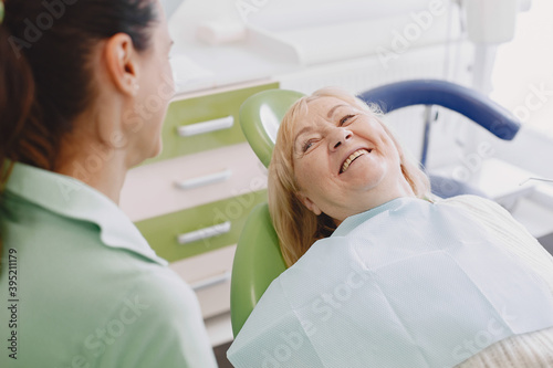 Senior woman having dental treatment at dentist s office. Woman is being treated for teeth