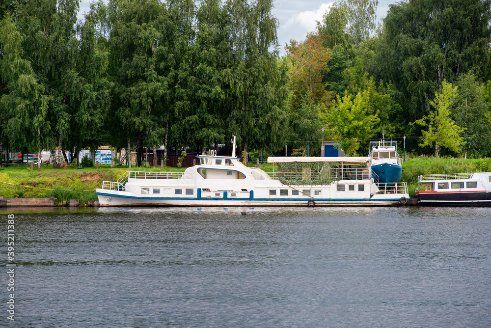 An old pleasure boat moored on the banks of the Volga River on a summer day