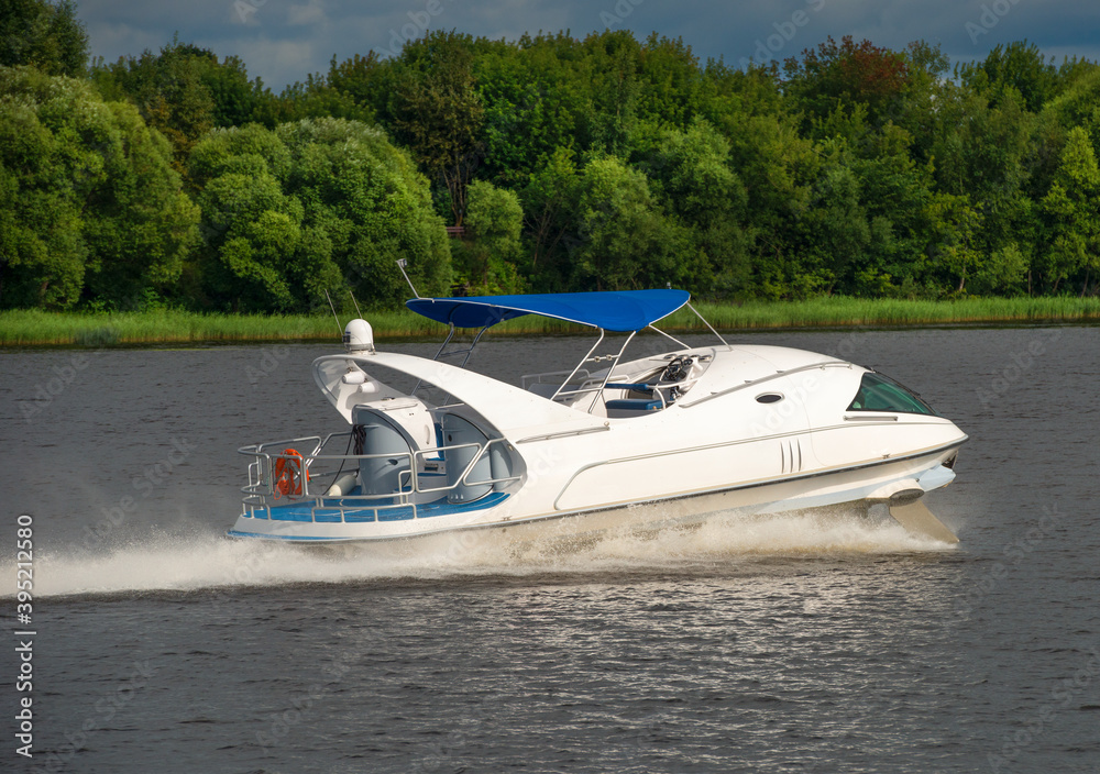 Fototapeta premium A hydrofoil boat moves at high speed along the river