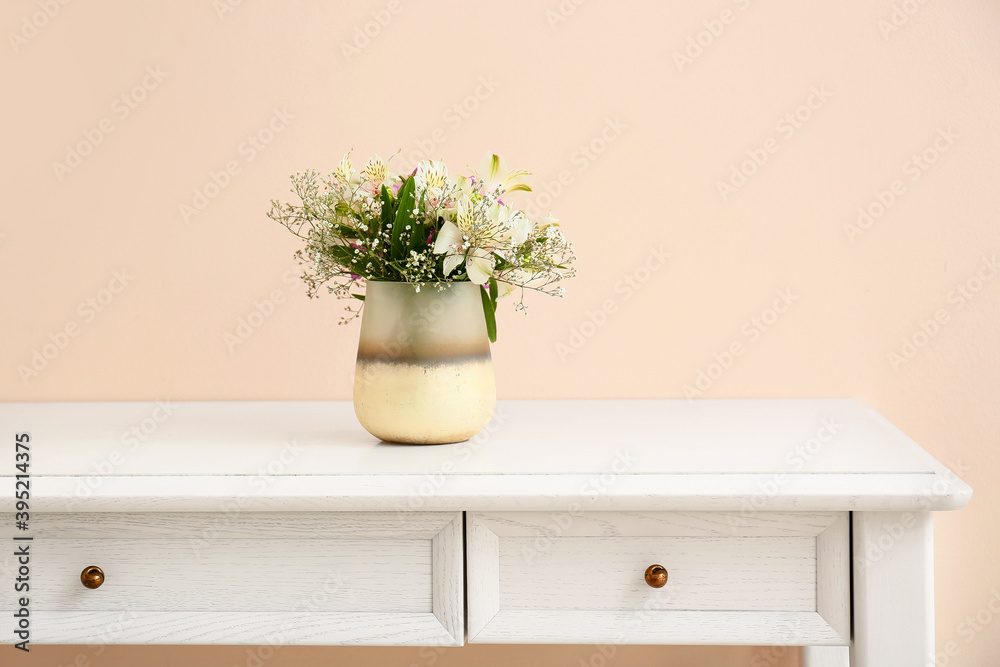 Beautiful vase with bouquet of flowers on table