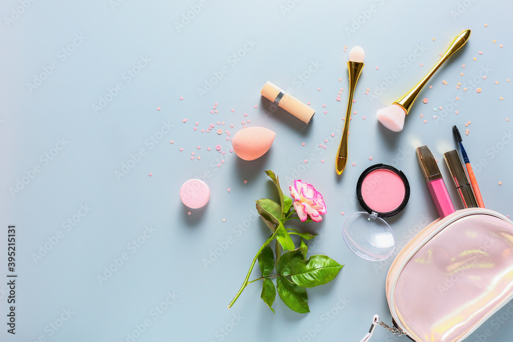 Composition with cosmetics, flower and bag on color background Composition with cosmetics, flower and bag on color background