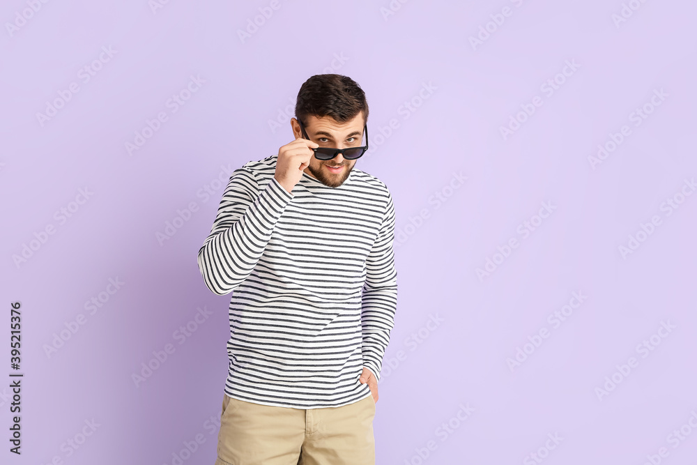 Handsome man with stylish sunglasses on color background Handsome man with stylish sunglasses on color background