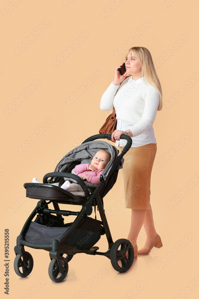 Woman and her cute baby in stroller on color background Woman and her cute baby in stroller on color background