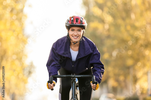 Female cyclist riding bicycle outdoors © Pixel-Shot