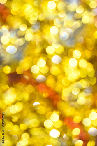 Abstract bokeh background. Texture with shining blurred multicolored lights. Christmas festive background with gold, red and silver lights. Blurred background with space for text.