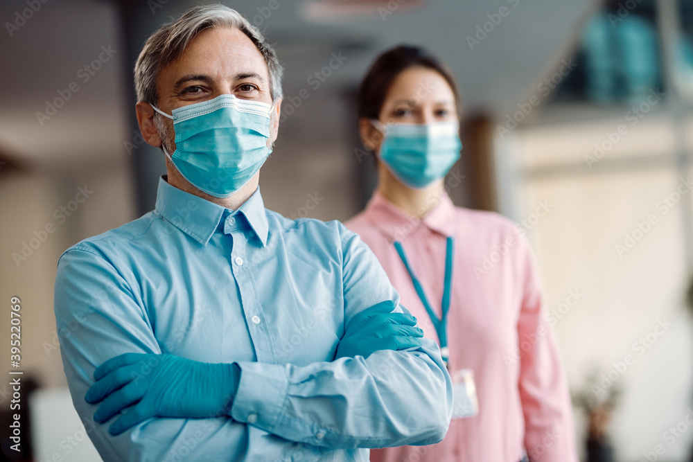 Confident businessman wearing face mask and gloves due to COVID-19 pandemic. Confident businessman wearing face mask and gloves due to COVID-19 pandemic.