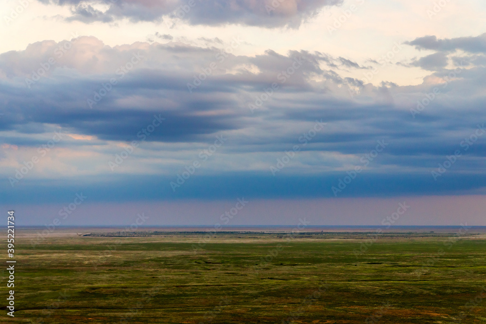 Scenic sunset with clouds in sky in steppe