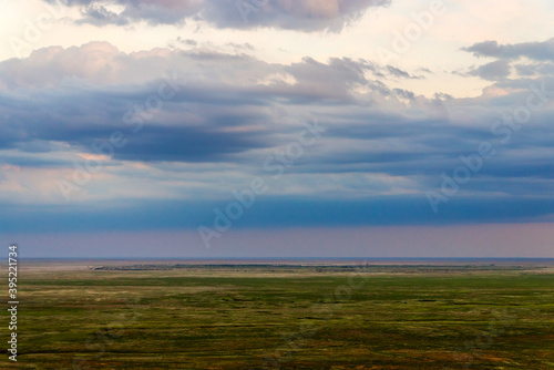 Scenic sunset with clouds in sky in steppe