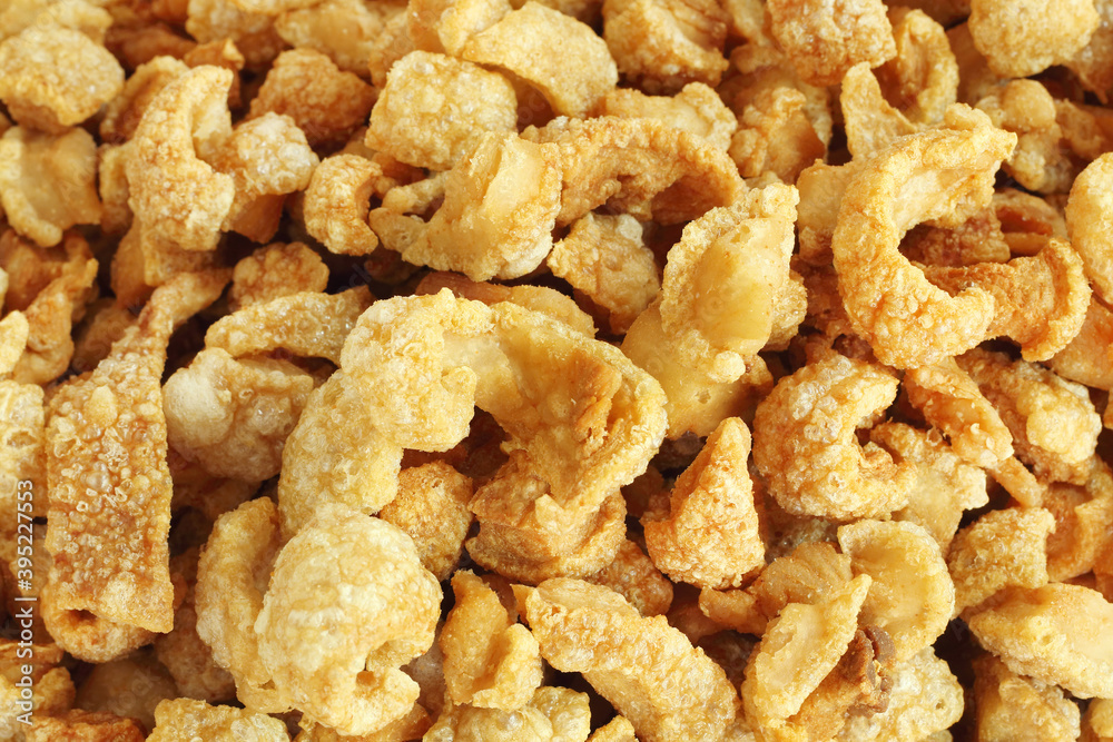 Close up of pork snack or pork scratching at market, crispy fried pork skin and blistered is traditional food in the north of Thailand. Close up of pork snack or pork scratching at market, crispy fried pork skin and blistered is traditional food in the north of Thailand.