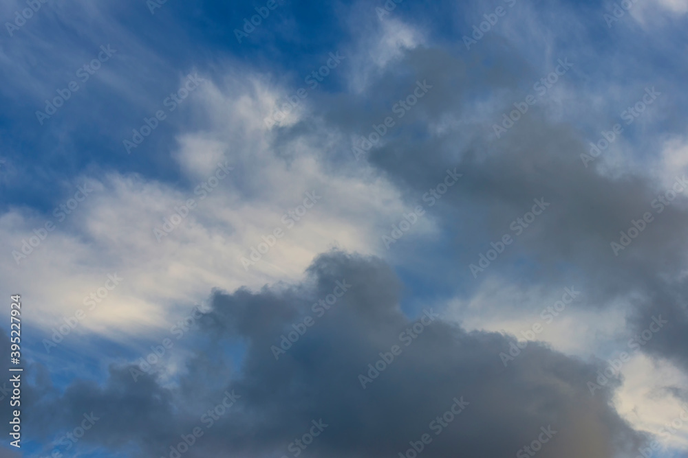 Grey white clouds in a blue sky in bright sunlight in autumn, Almere, Flevoland, The Netherlands, November 24, 2020