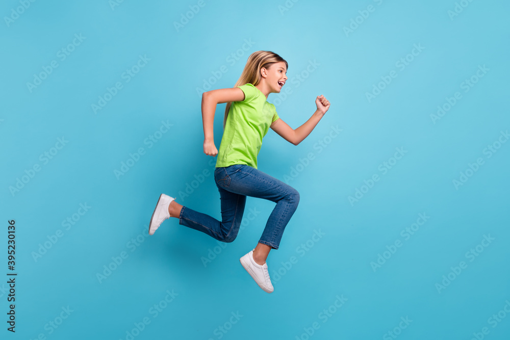 Photo portrait profile of girl running jumping up isolated on pastel blue colored background