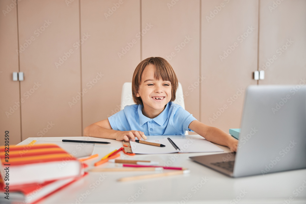 Funny kid happy to meet his classmates at the video chat Funny kid happy to meet his classmates at the video chat