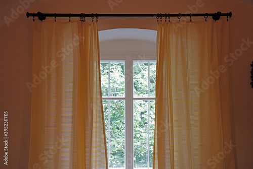 Wooden window with vintage curtains