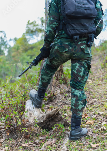 Army soldiers with guns walk patrol.Stay safe in the forest