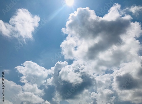 blue sky with heavy clouds and sunbeam