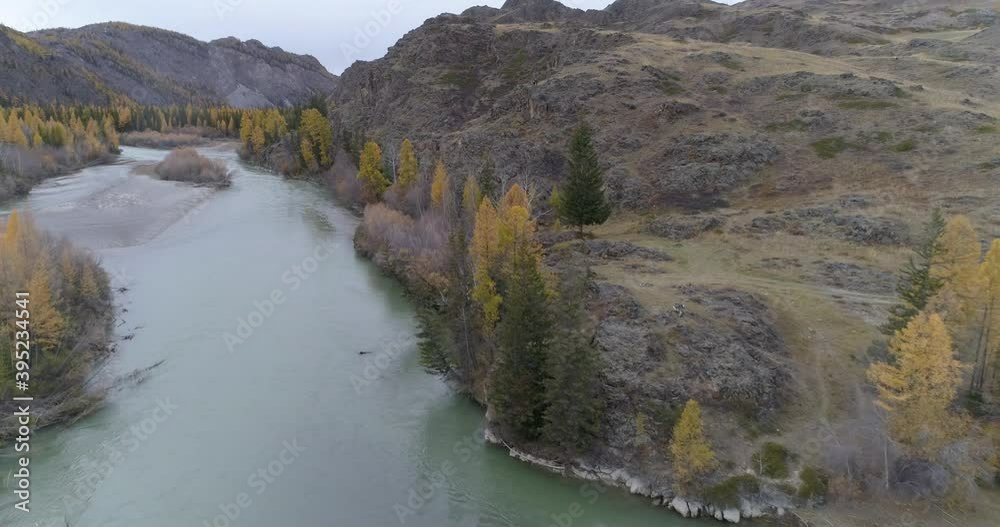 Dron flight over Chuya scenic mountain river flowing in rocky terrain at autumn, A fisherman is fly fishing, Altai Dron flight over Chuya scenic mountain river flowing in rocky terrain at autumn, A fisherman is fly fishing, Altai