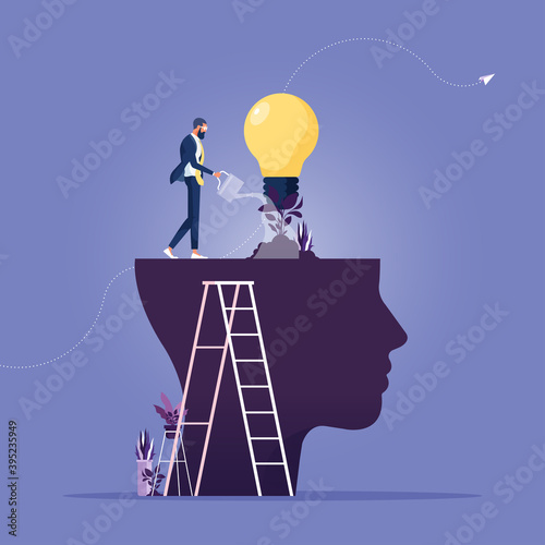 Personal growth-Self improvement and self development concept, Businessman watering that growing lightbulb plant from the brain as metaphor growth personality