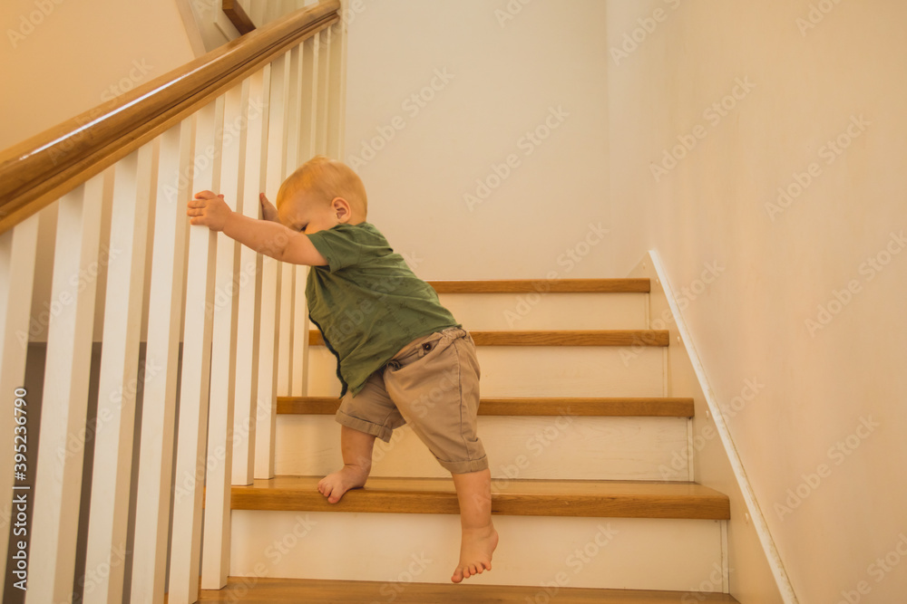 Toddler boy is training new skills on stairs