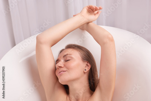 young beautiful woman enjoying in bathtub. Concept of spa at home