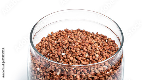 Transparent jar with buckwheat on a white background. High quality photo