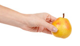 Hand with fresh yellow pear isolated on white background.