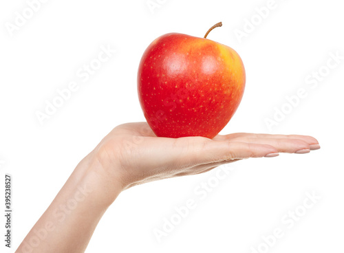 Hand with fresh red apple isolated on white background.