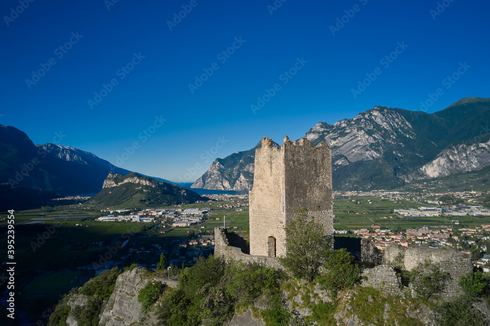 Flying on drone, aerial view of Arco Castle ruins, Lake Garda. Italy. Arco Medieval Castle on the top of the rock.