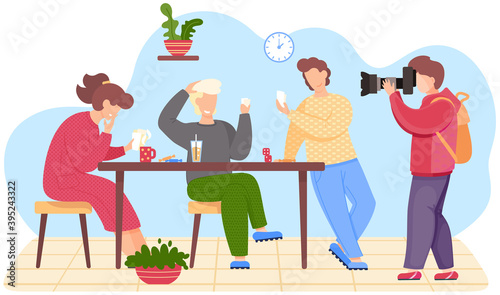 Best friends take a group photo. Young man taking pictures of people playing cards. Friends are drinking a juice and coffee at the table. omrades are having a good time visiting one of them