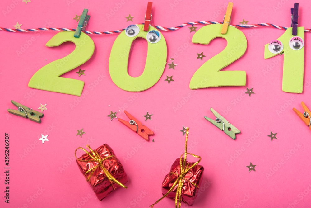 2021 New Year Celebration on rope with clothespins. Design for calendar, banner greeting cards or print, pink background.