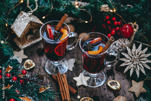  Hot homemade mulled wine with oranges and rosemary in a New Year's atmosphere