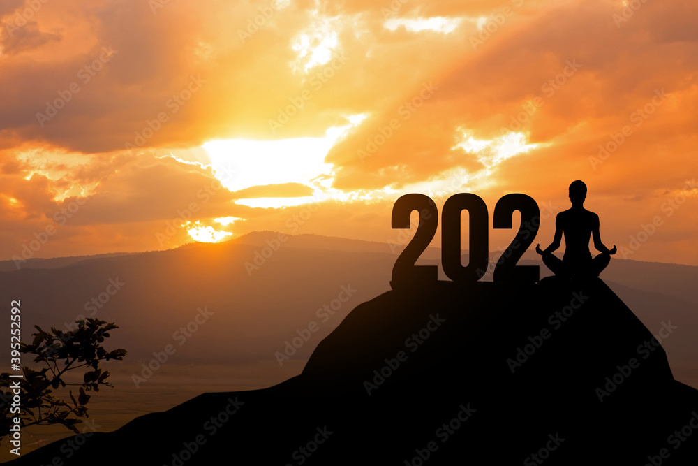 Concept of New 2021.silhouette of woman yoga on the mountain with 2021 year. Concept of New 2021.silhouette of woman yoga on the mountain with 2021 year.