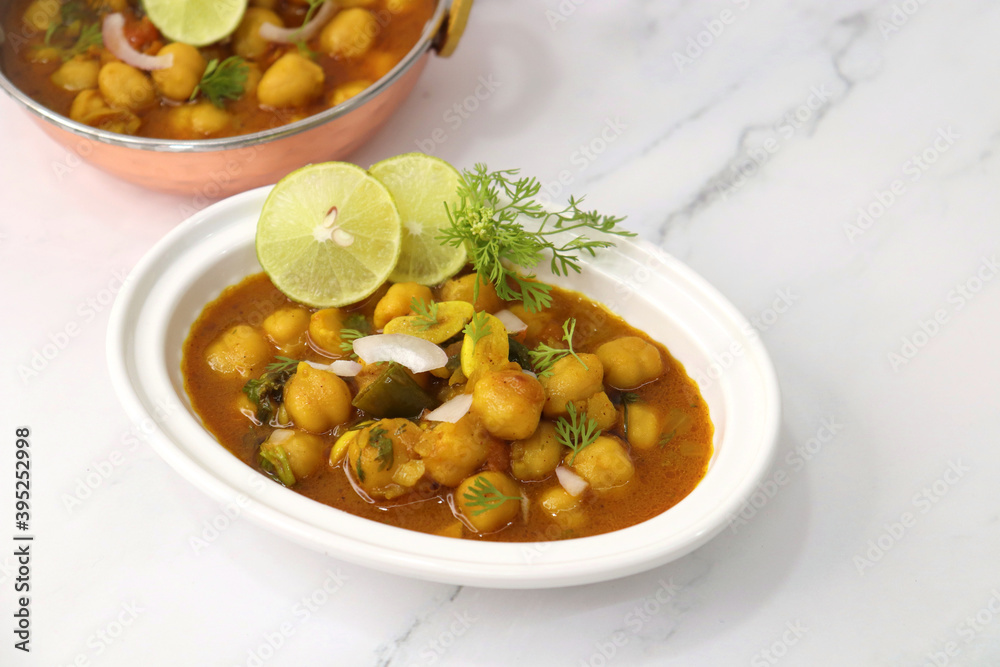 Indian food. Fresh chickpea masala, Chole masala curry, traditional north Indian dish. Popular Amritsari Chole bhature. Chana masala Garnished with lemon and onion. food photography. Copy space. Indian food. Fresh chickpea masala, Chole masala curry, traditional north Indian dish. Popular Amritsari Chole bhature. Chana masala Garnished with lemon and onion. food photography. Copy space.