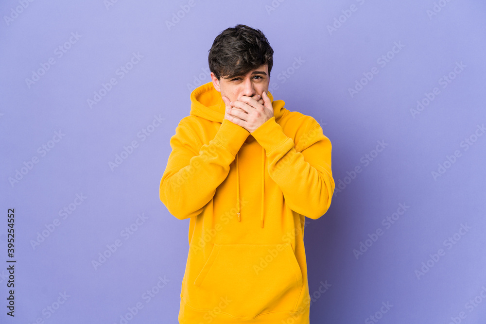 Young cool man covering mouth with hands looking worried. Young cool man covering mouth with hands looking worried.