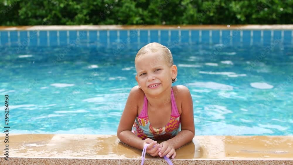Lonely first-grader girl in the pool. Pandemic, lockdown Lonely first-grader girl in the pool. Pandemic, lockdown