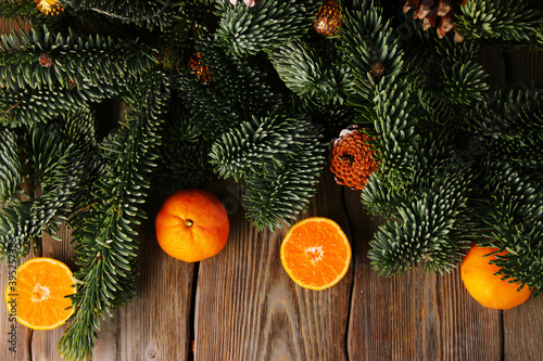 christmas background. christmas tree and tangerin or mandarin on wooden table. concept of new year top view