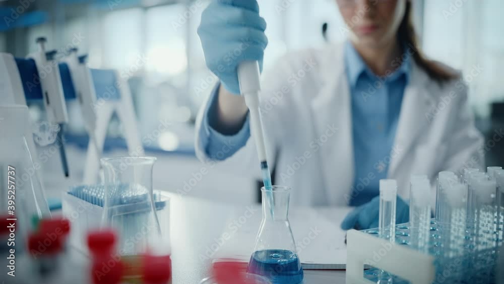 Medical Research Laboratory: Portrait of a Beautiful Female Scientist in Goggles Using Micro Pipette for Test Analysis. Advanced Scientific Lab for Medicine, Biotechnology, Microbiology Development Medical Research Laboratory: Portrait of a Beautiful Female Scientist in Goggles Using Micro Pipette for Test Analysis. Advanced Scientific Lab for Medicine, Biotechnology, Microbiology Development