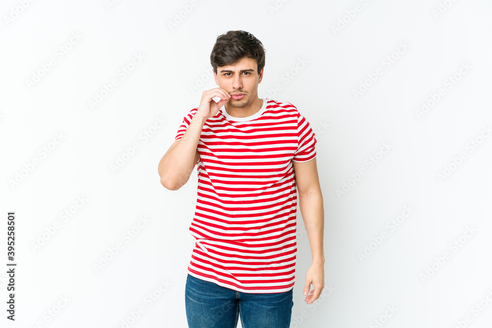 Young cool man with fingers on lips keeping a secret. Young cool man with fingers on lips keeping a secret.