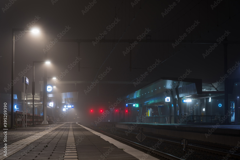 Foggy night at a modern railway platform in a city. Foggy night at a modern railway platform in a city.