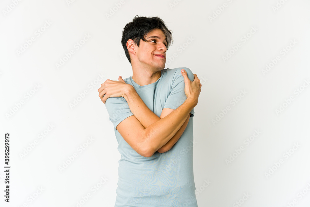 Young skinny hispanic man hugs, smiling carefree and happy. Young skinny hispanic man hugs, smiling carefree and happy.