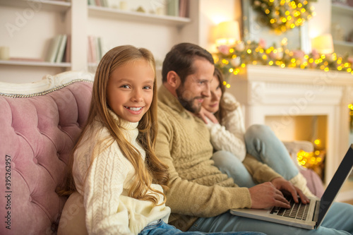 Young family watching something on a laptop