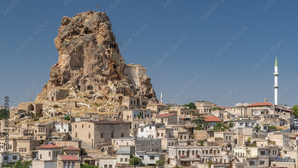 View of Ortahisar town old houses in rock formations from Ortahisar Castle aerial timelapse.