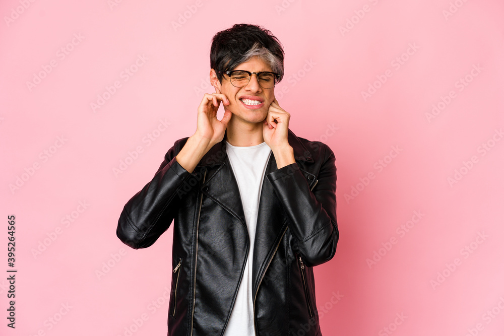 Young skinny hispanic man covering ears with fingers, stressed and desperate by a loudly ambient. Young skinny hispanic man covering ears with fingers, stressed and desperate by a loudly ambient.