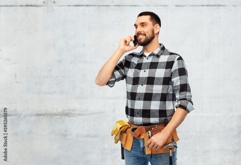 communication, construction and building concept - happy smiling worker or builder calling on smartphone over grey background