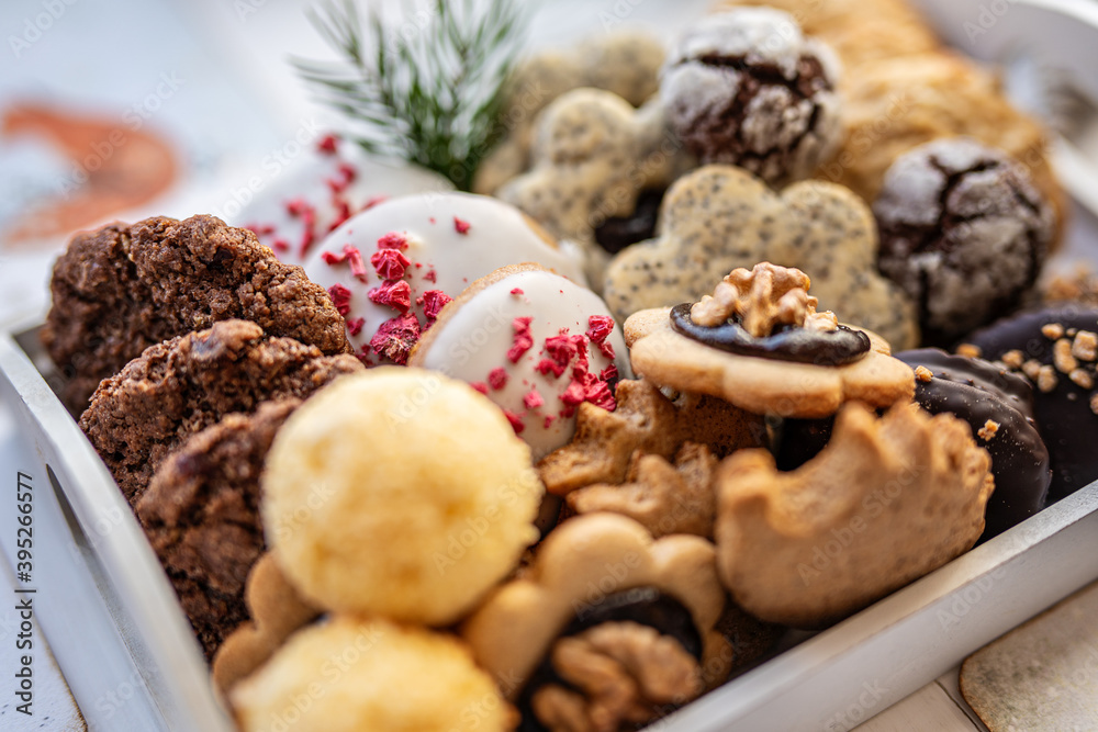 Fototapeta premium Close up of christmas cakes and cookies with santa hat 