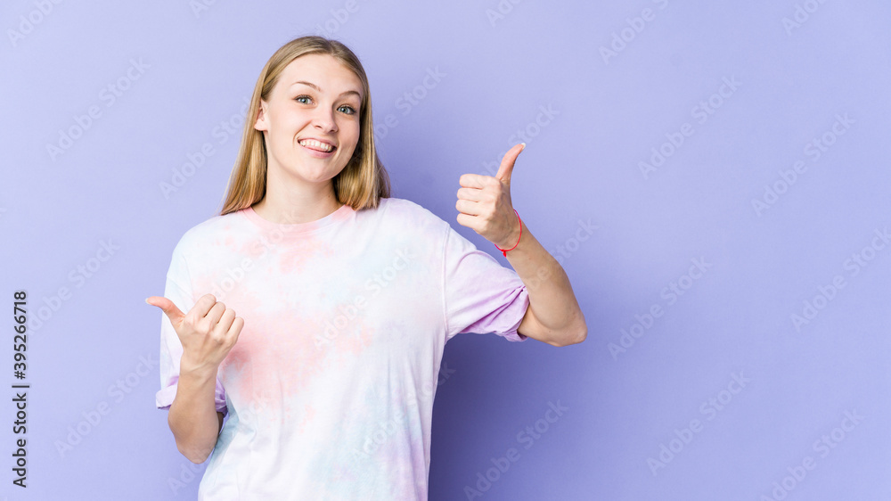 Young blonde woman isolated on purple background raising both thumbs up, smiling and confident. Young blonde woman isolated on purple background raising both thumbs up, smiling and confident.