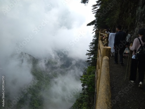 People on a cat walk on a cliff, Yichun, Ming Yue Mountains, China. photo