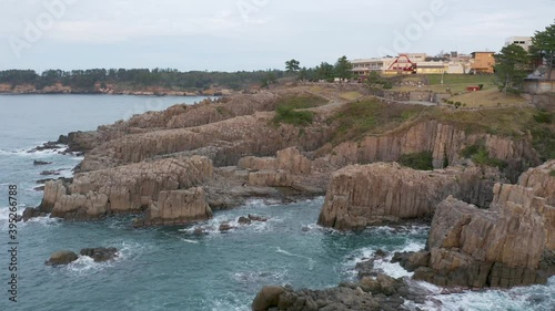 Aerial pan shot of Tojinbo Coastal Cliffs Japan's Volcanic Causeway photo