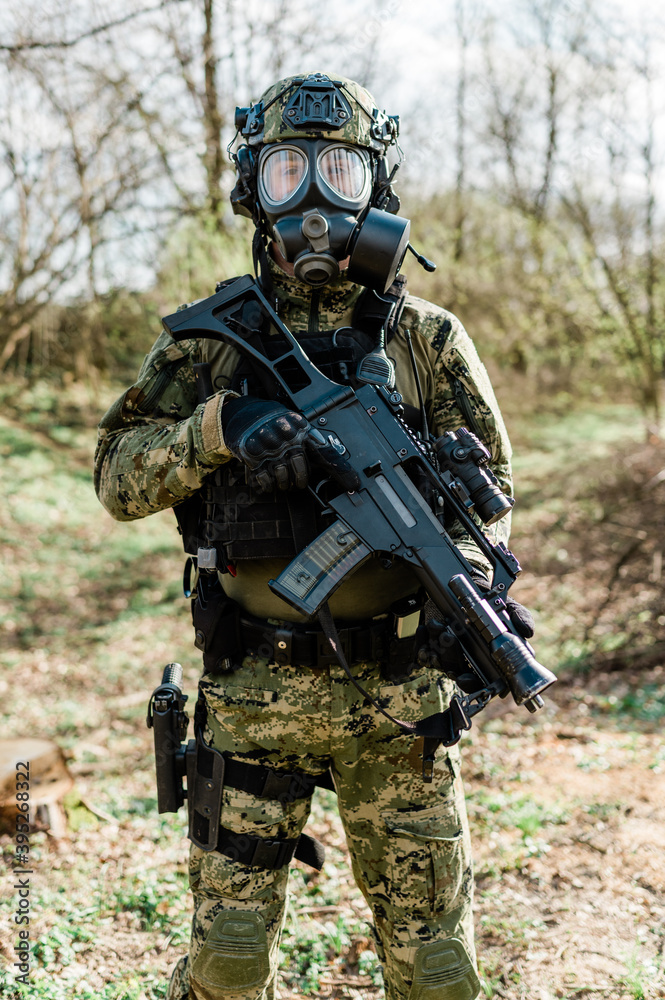 Croatian soldier wearing cropat uniform, protective gas mask M95 and carrying assault rifle G36