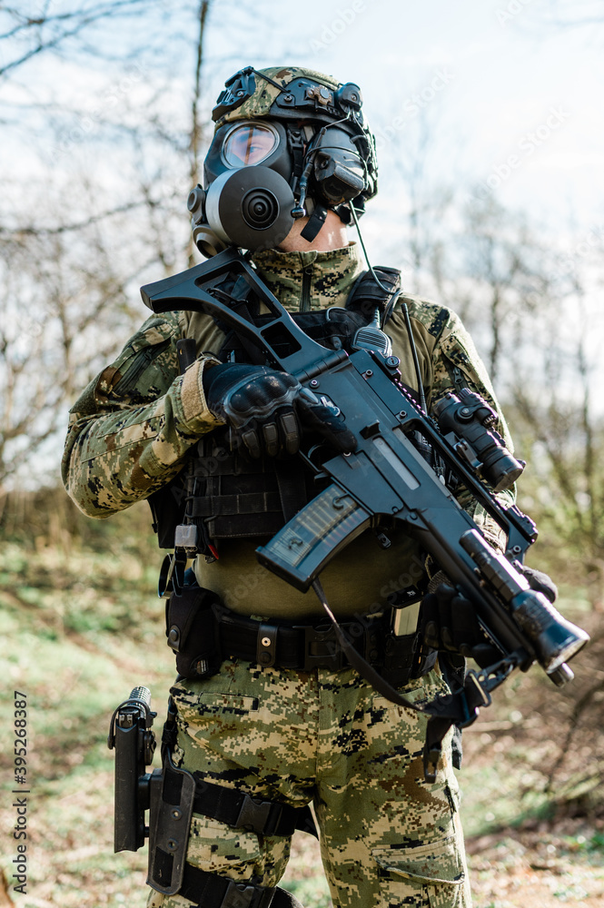 Croatian soldier wearing cropat uniform, protective gas mask M95 and carrying assault rifle G36